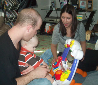 Two adults playing with child