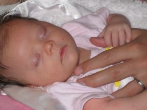 Baby with Adult Hand on Chest