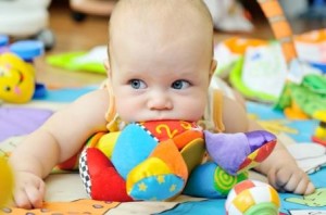 Baby with Soft Toy in Mouth