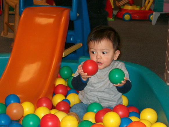 Toddler playing with balls