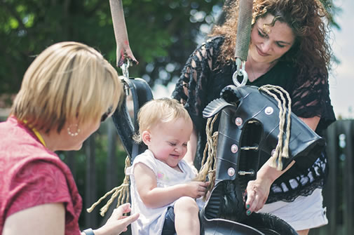 2 Women with toddler on swing